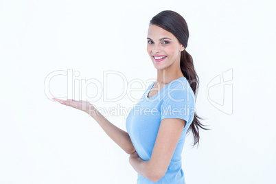 Woman smiling presenting something with her hand