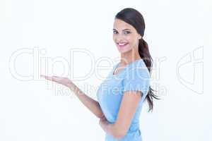 Woman smiling presenting something with her hand