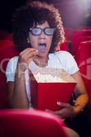 Surprised young woman watching a 3d film