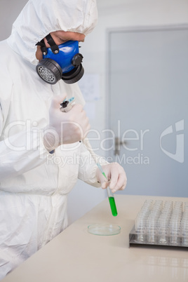 Scientist in protective suit doing experimentations