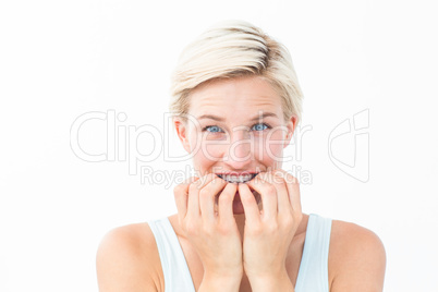 Nervous woman biting her nails looking at camera