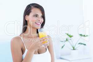 Happy woman holding glass of juice