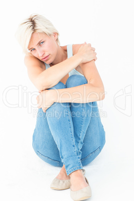 Depressed blonde looking at camera