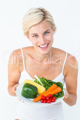 Beautiful woman holding vegetables plate