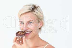 Attractive woman eating muffin