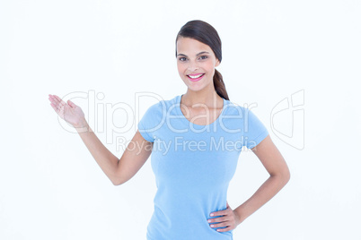 Woman smiling presenting something with her hand