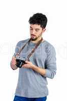Casual man looking at his camera