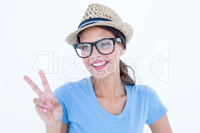 Smiling woman making peace and love gesture