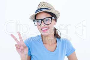 Smiling woman making peace and love gesture