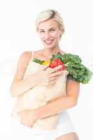 Attractive woman holding bag of vegetables