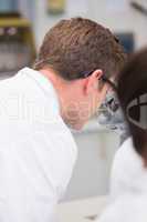 Scientist looking through a microscope