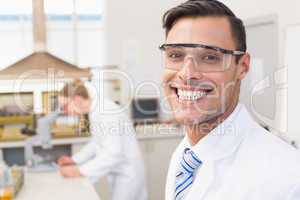 Happy scientist smiling at camera