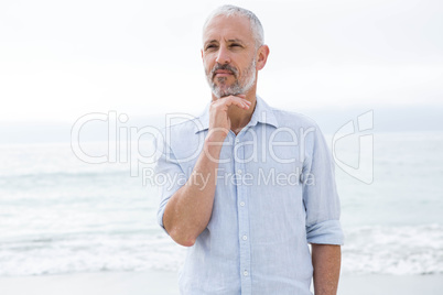 Thoughtful man standing by the sea