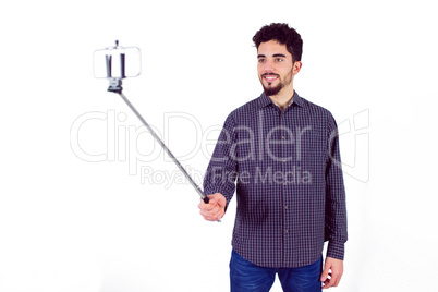 Casual man using a selfie stick