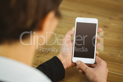 Businesswoman using phone at desk