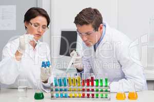 Scientists working attentively with test tube