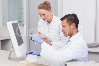 Scientists looking at computer