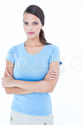 Unsmiling woman looking at camera with arms crossed