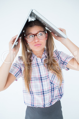 Geeky hipster holding her laptop over her head