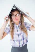 Geeky hipster holding her laptop over her head