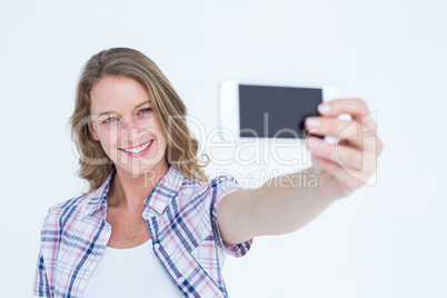 Pretty hipster taking selfie with smartphone