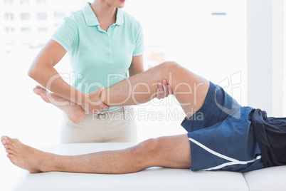 Doctor examining man leg