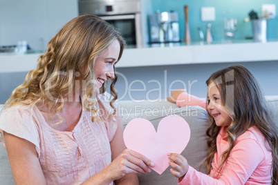 Happy mother and daughter on the couch