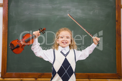 Cute pupil holding violin and violin string