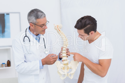 Doctor explaining anatomical spine to his patient