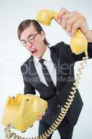Geeky businessman shouting and hanging up the telephone