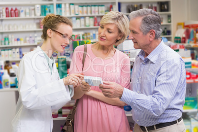 Pharmacist explaining the drug to costumers