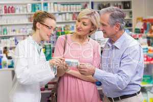 Pharmacist explaining the drug to costumers