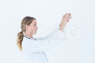 Serious doctor preparing syringe