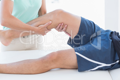 Doctor examining man leg