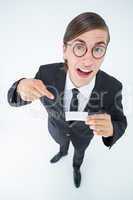 Geeky businessman looking at camera and pointing at card