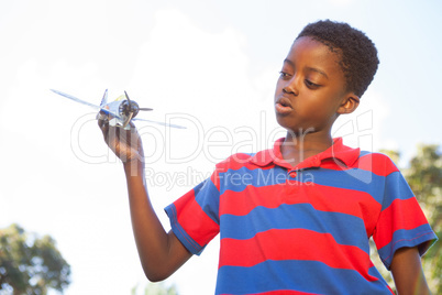 Little boy playing with toy airplane