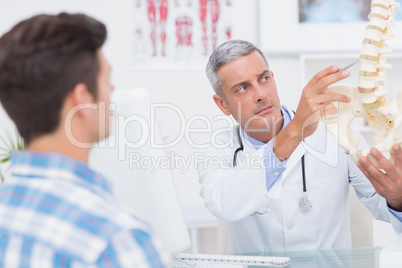 Doctor explaining anatomical spine to his patient