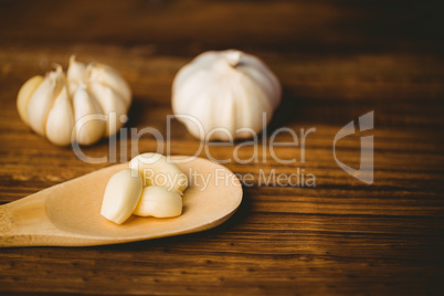 Garlic cloves and bulb on chopping board
