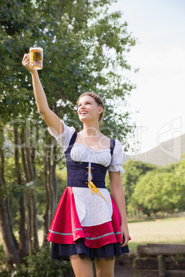 Pretty oktoberfest girl holding beer tankard