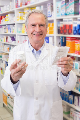 Senior holding medicine box and prescription Senior holding medicine box and prescription