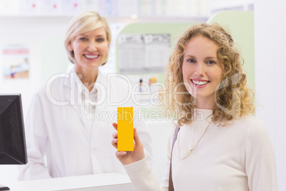 Smiling costumer with a medicine bottle