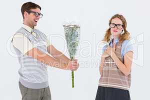 Geeky hipster offering flowers to his girlfriend