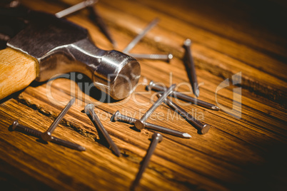 Hammer and nails laid out on table