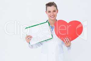 Happy doctor holding clipboard and heart card