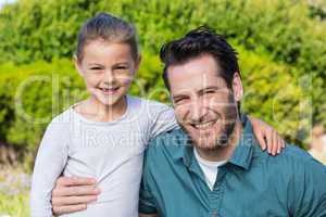 Father and daughter smiling at camera