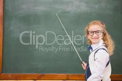 Happy pupil pointing the blackboard