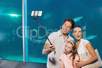 Happy family using selfie stick