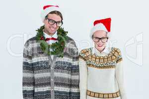 Happy geeky hipster couple looking at camera