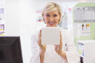 Pharmacist holding medicine box