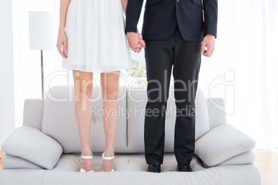 Couple standing on the couch